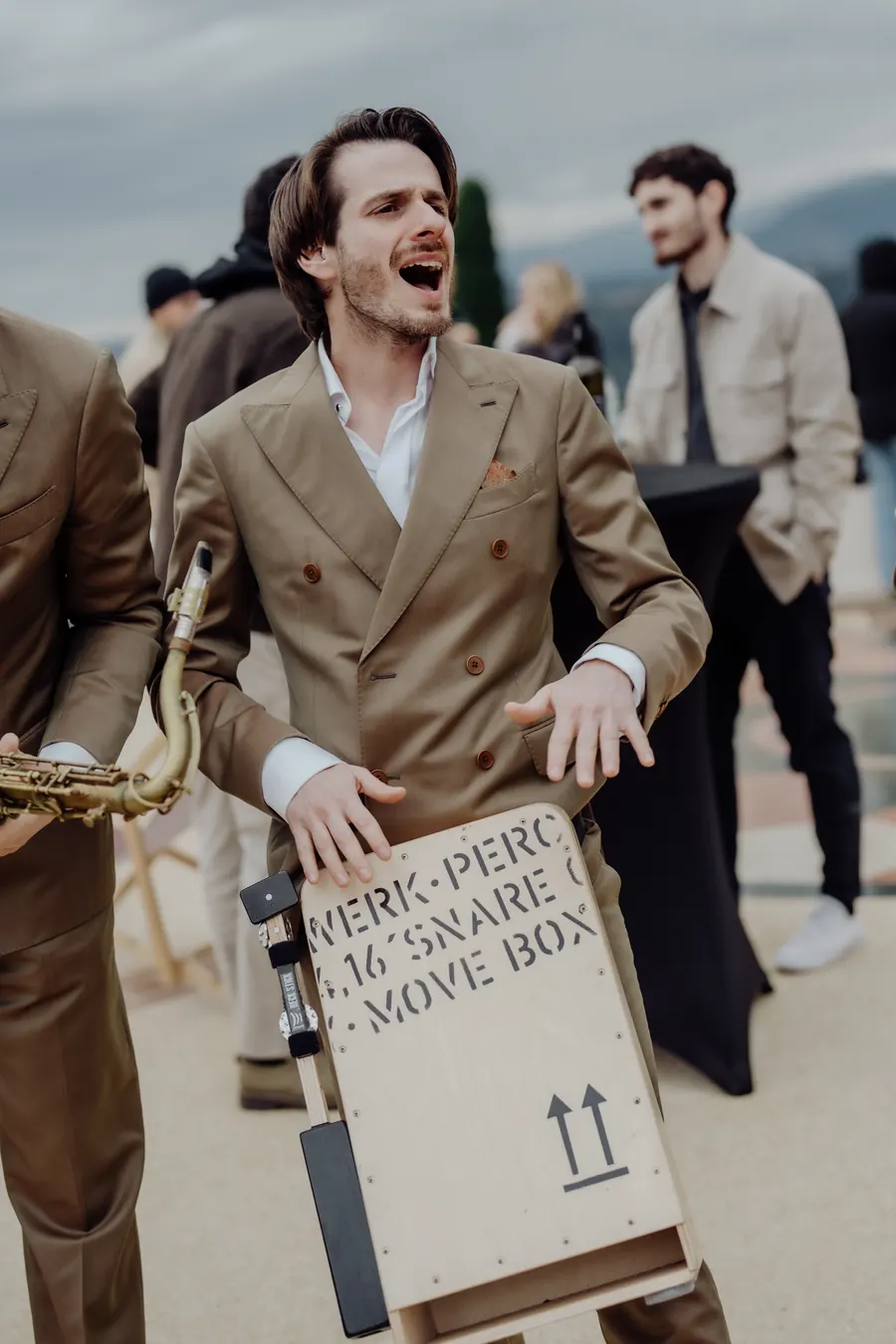 The singer carrying the cajon box between sets