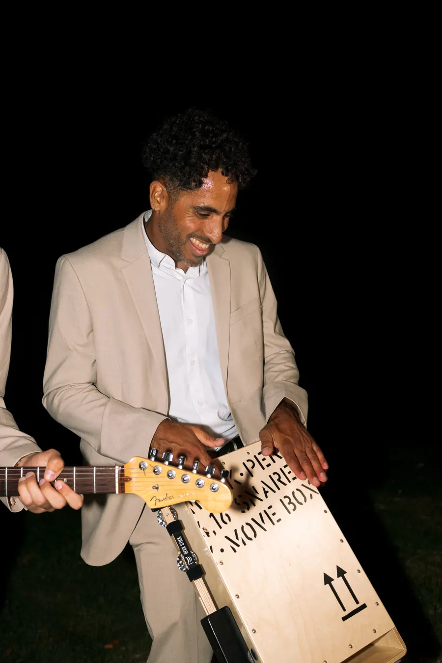 Percussionist with the cajon box at a garden party