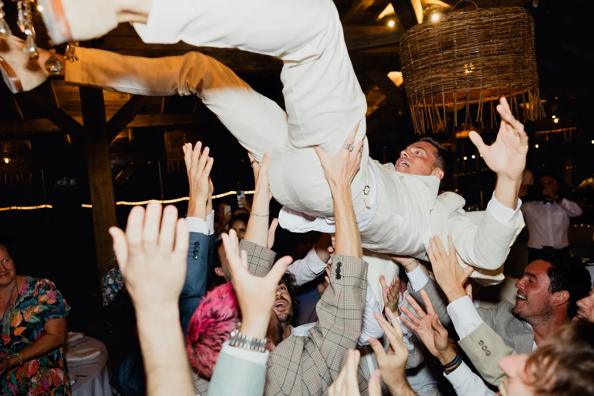 A guest lifted by the crowd as the band plays