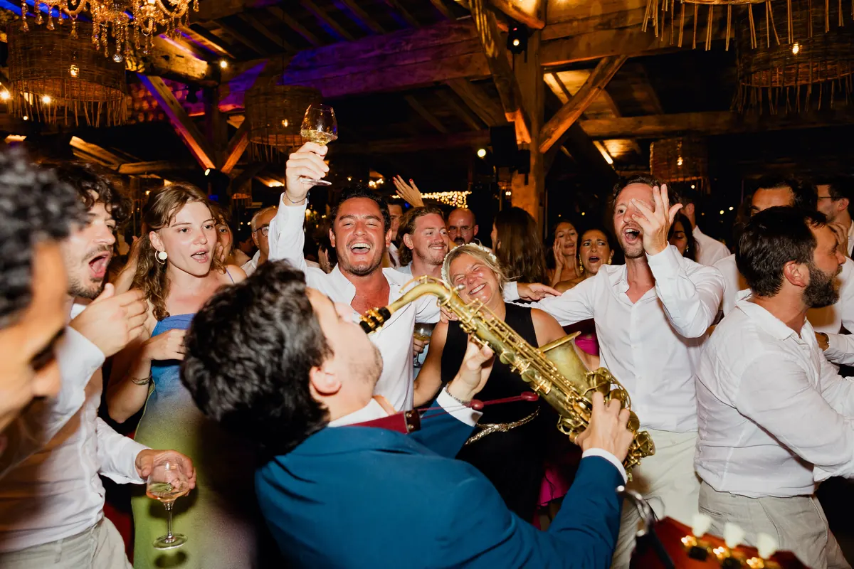 The Gentlemen playing to a packed room, saxophone in front