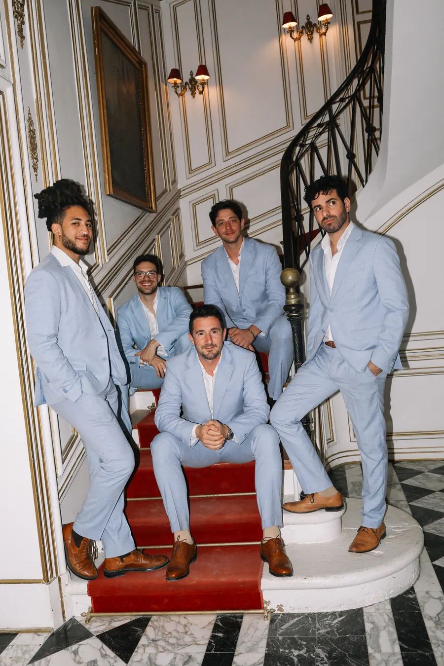 The Kingsmen on a grand staircase
