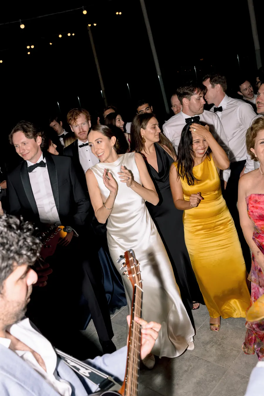 Guests dancing with the band at a black-tie evening