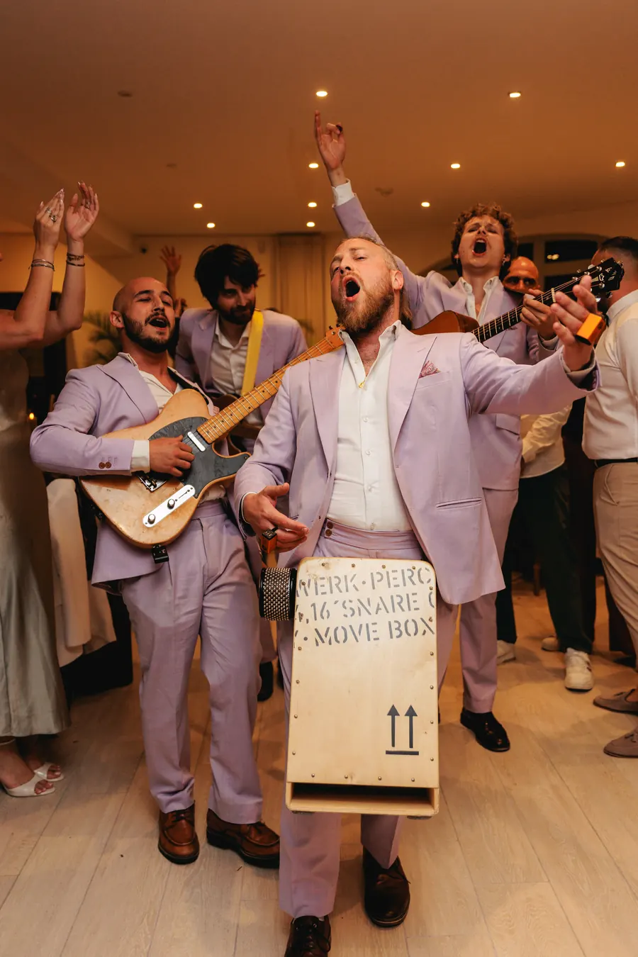 The band leading a conga line indoors