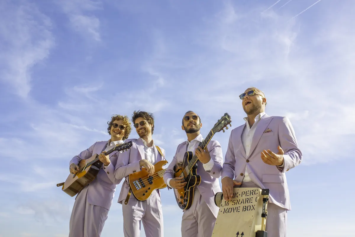 The band against a blue summer sky
