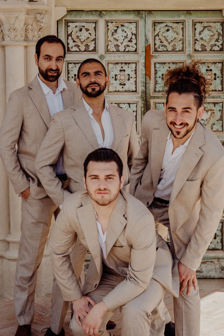 The band in beige suits in a baroque doorway