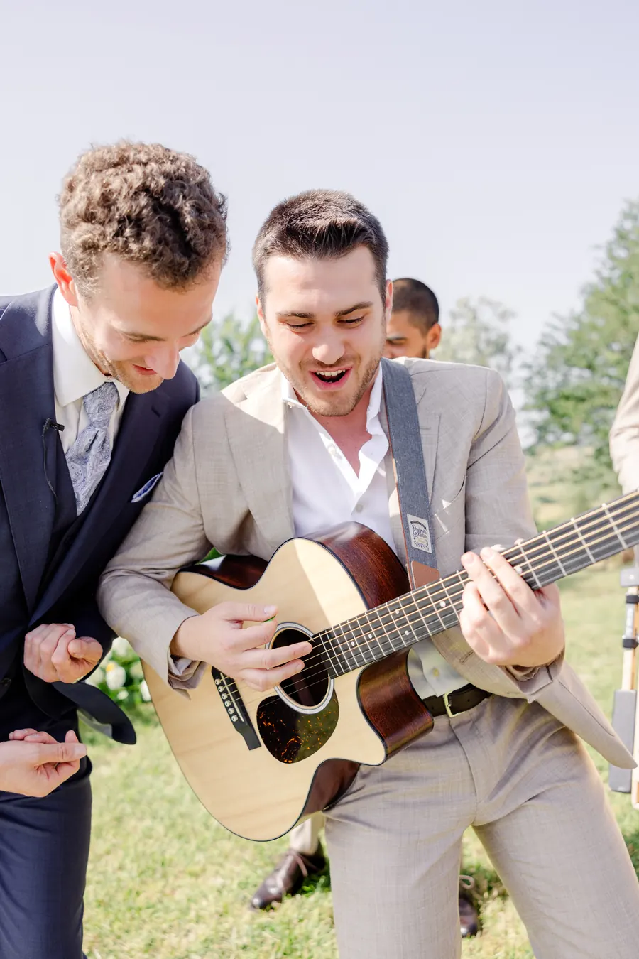 Singer and guitarist on a lawn