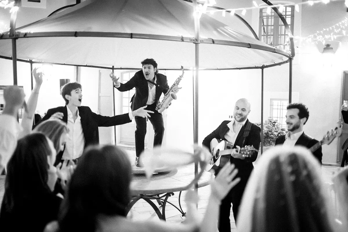 The band on a gazebo among the guests