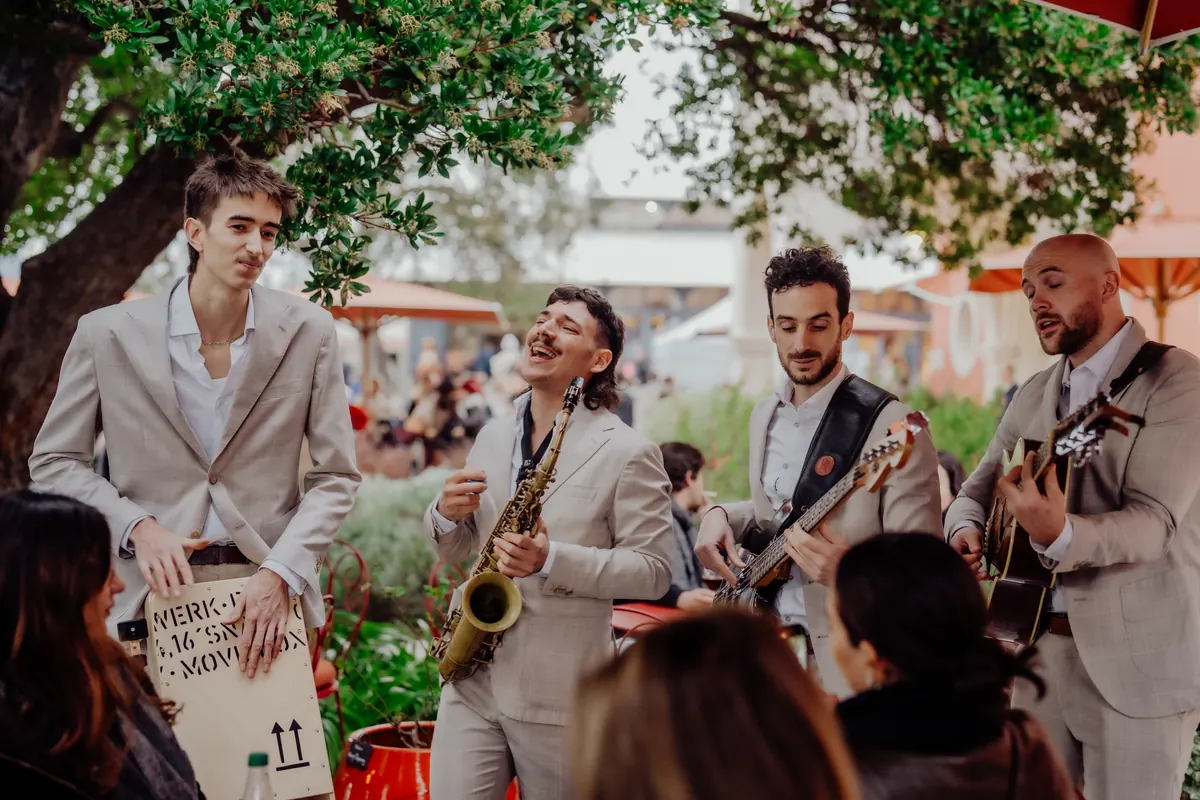 The band playing to a table under the trees