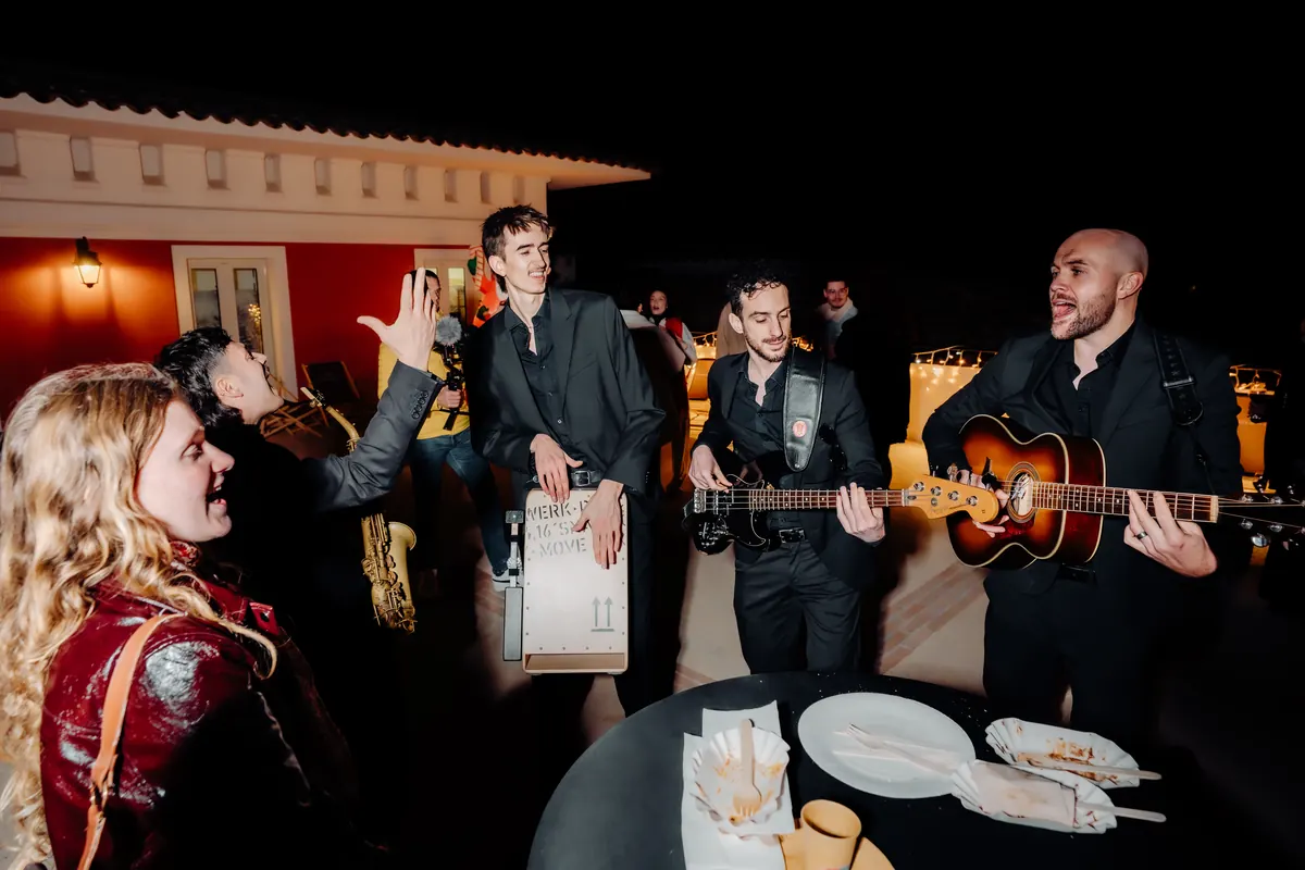 Guests dancing around the band at a villa