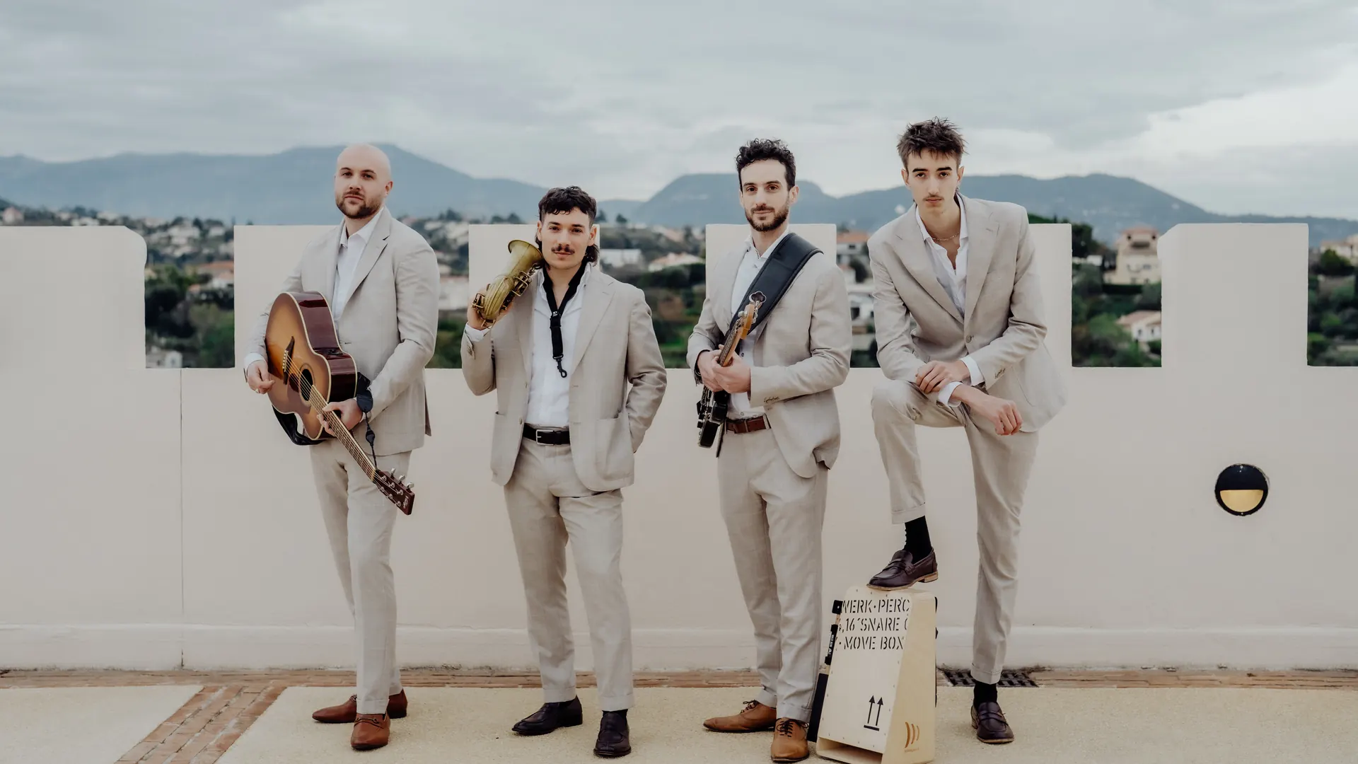 The Supersonics with their instruments on a hilltop terrace