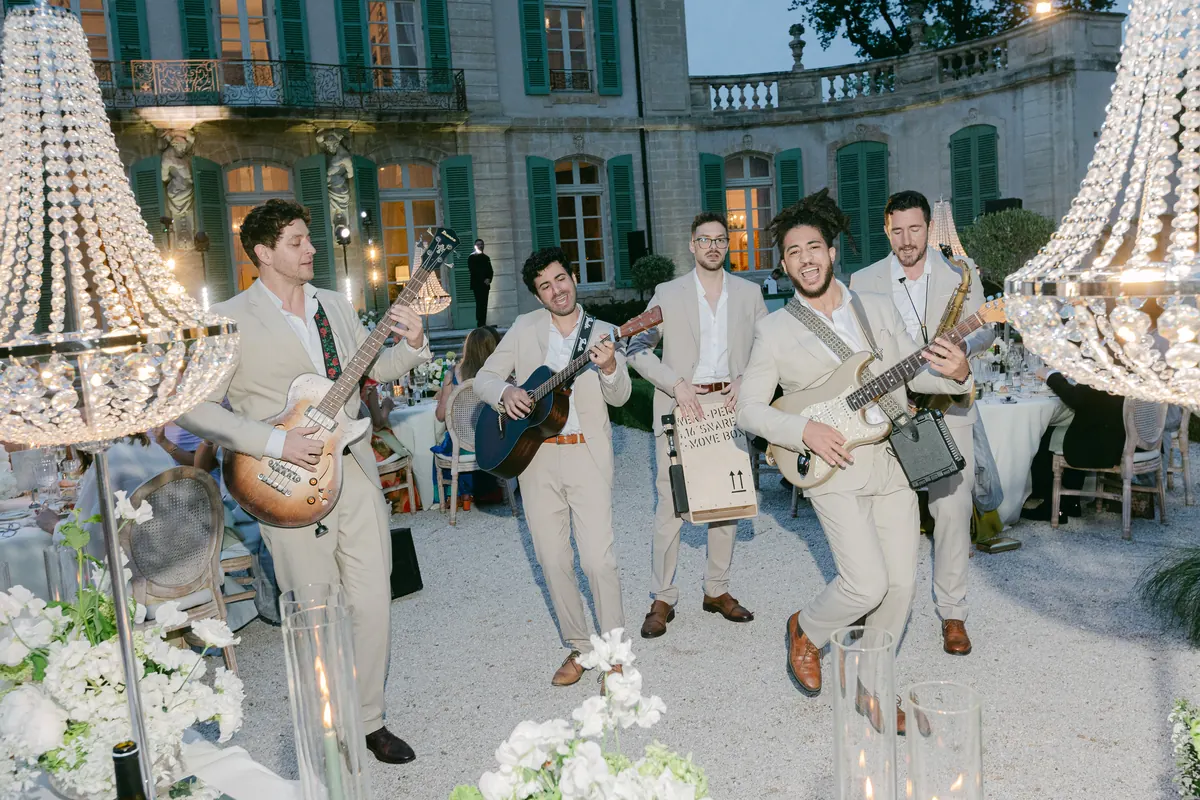 The band under a chandelier at a château reception