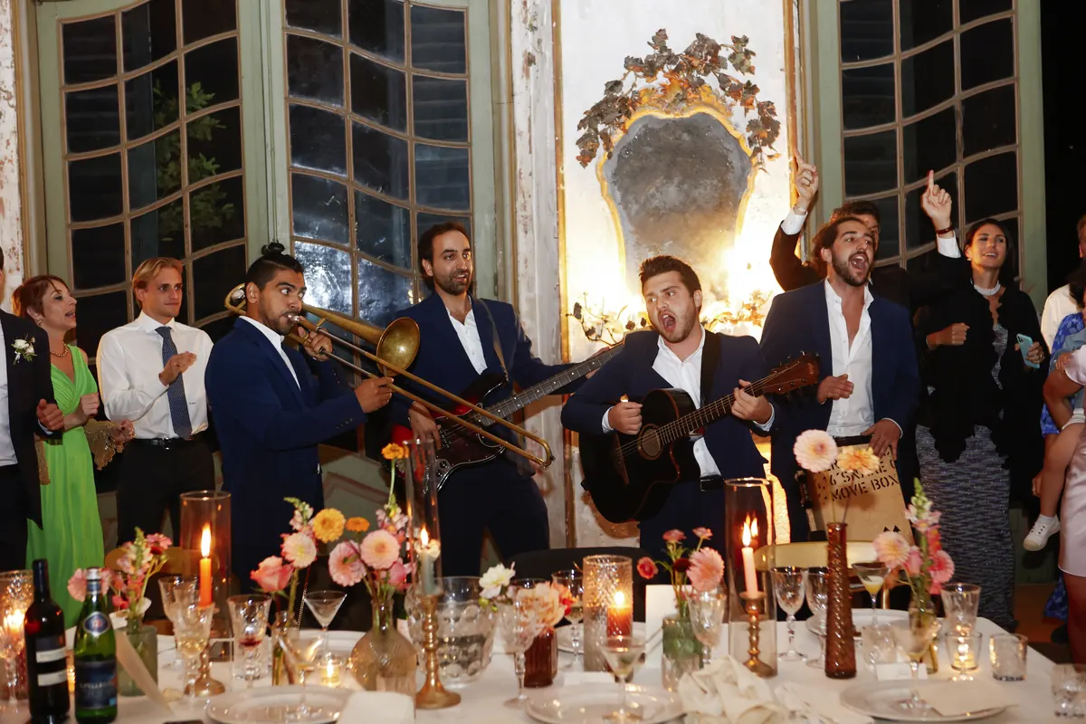 The band at a candlelit dinner in a mirrored salon
