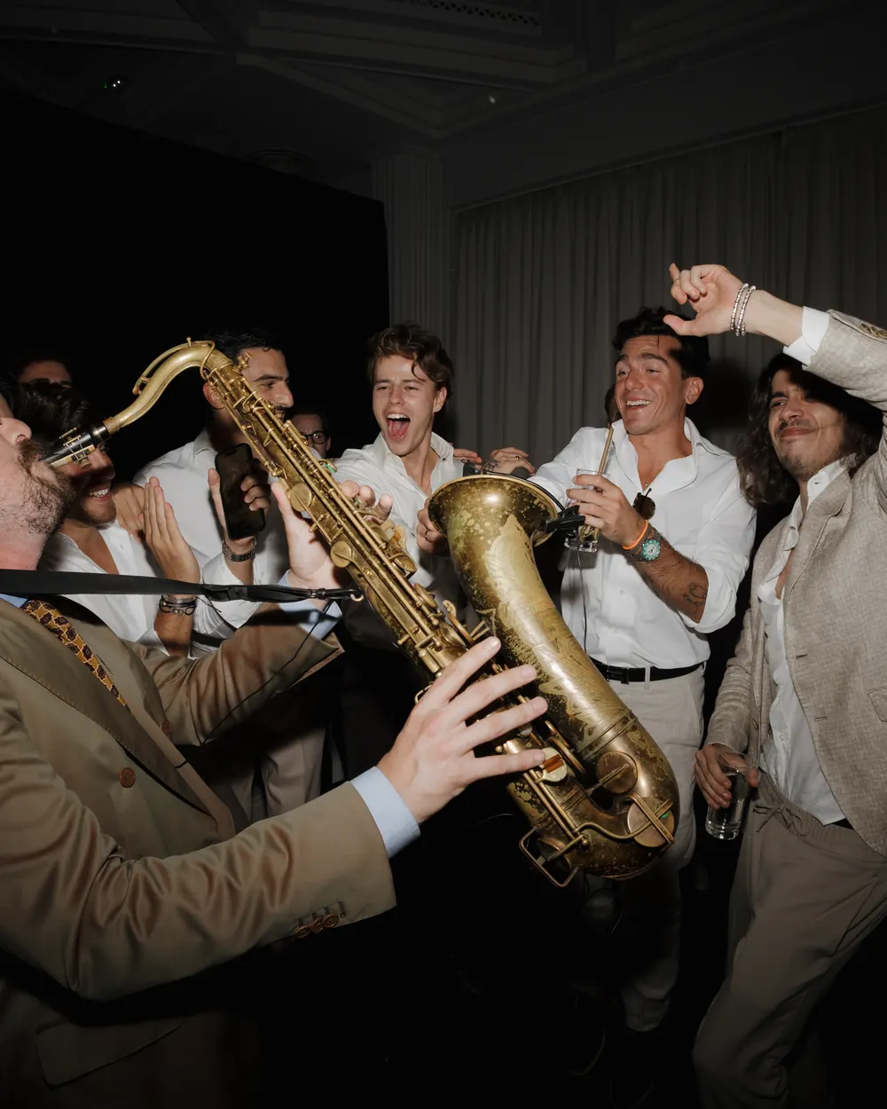 Saxophonist playing among the dancers