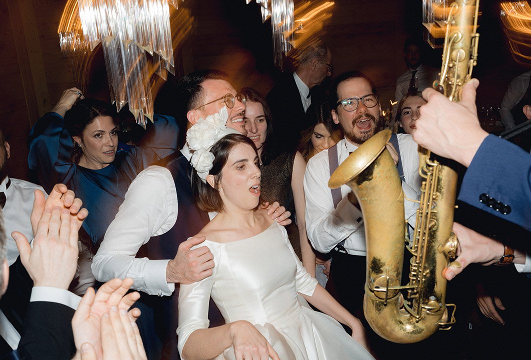 The saxophonist playing among guests at dinner