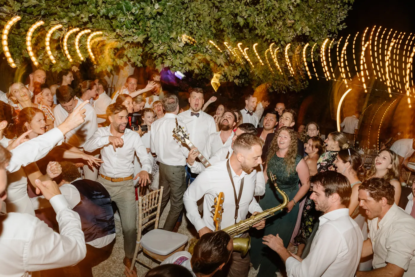 The band in the middle of a packed dancefloor