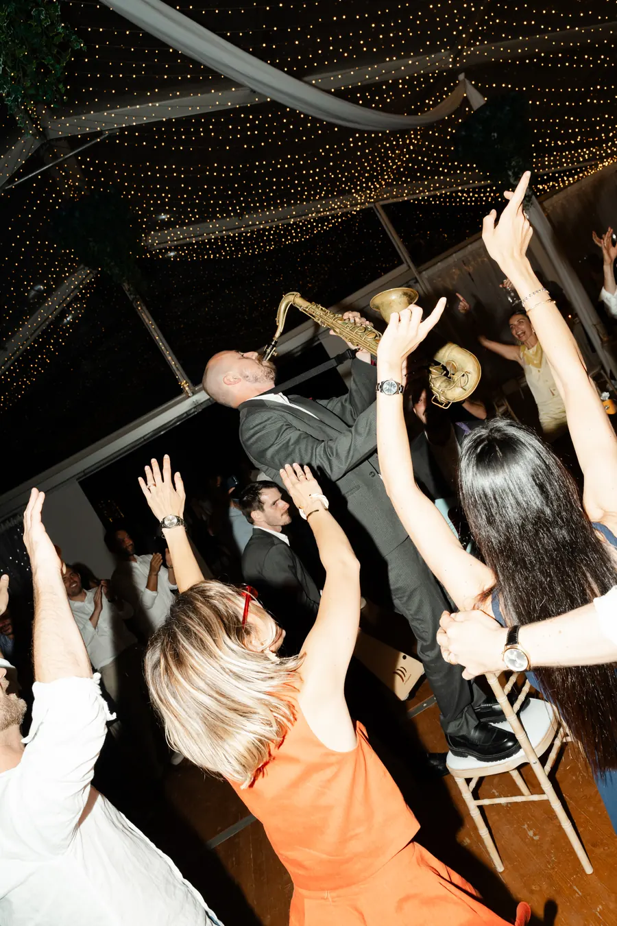 Guests dancing under a canopy of lights at a private party