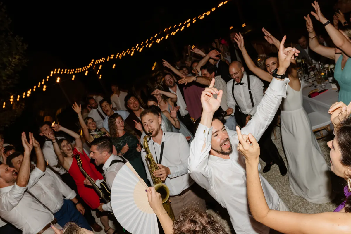 Guests and the band around a garden bar at night