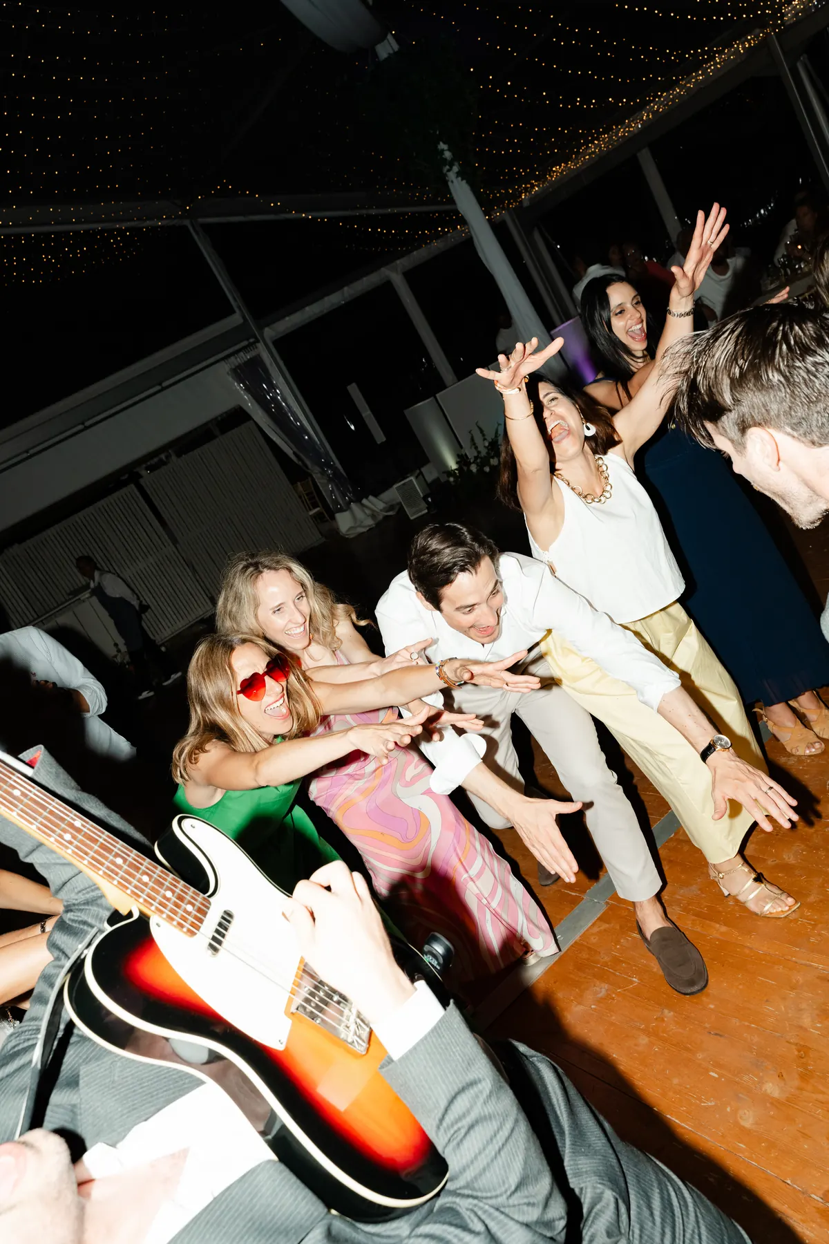 A guest dancing with the band in a garden