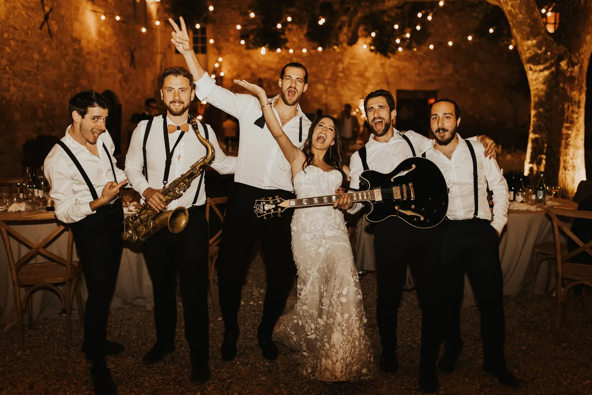 The band with the couple under the lights at the end of the night