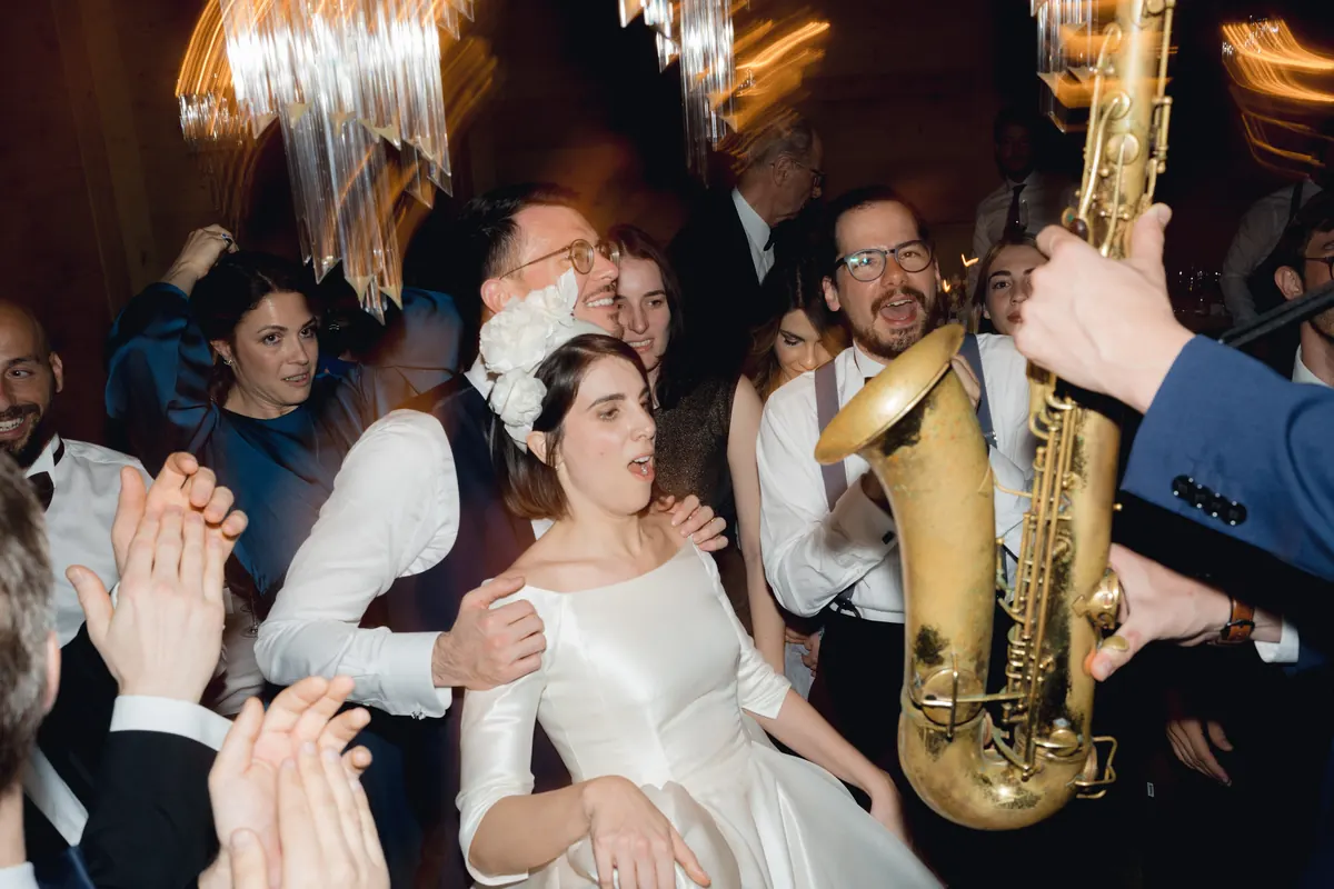 The bride in the middle of the dancefloor with the saxophonist