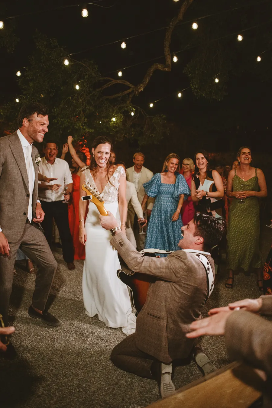 Guests dancing under string lights