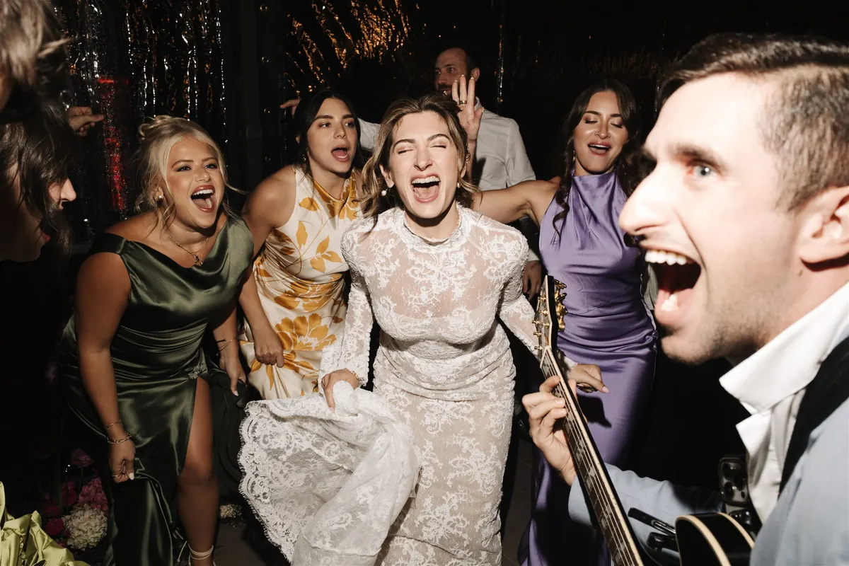 The band and the wedding party singing together