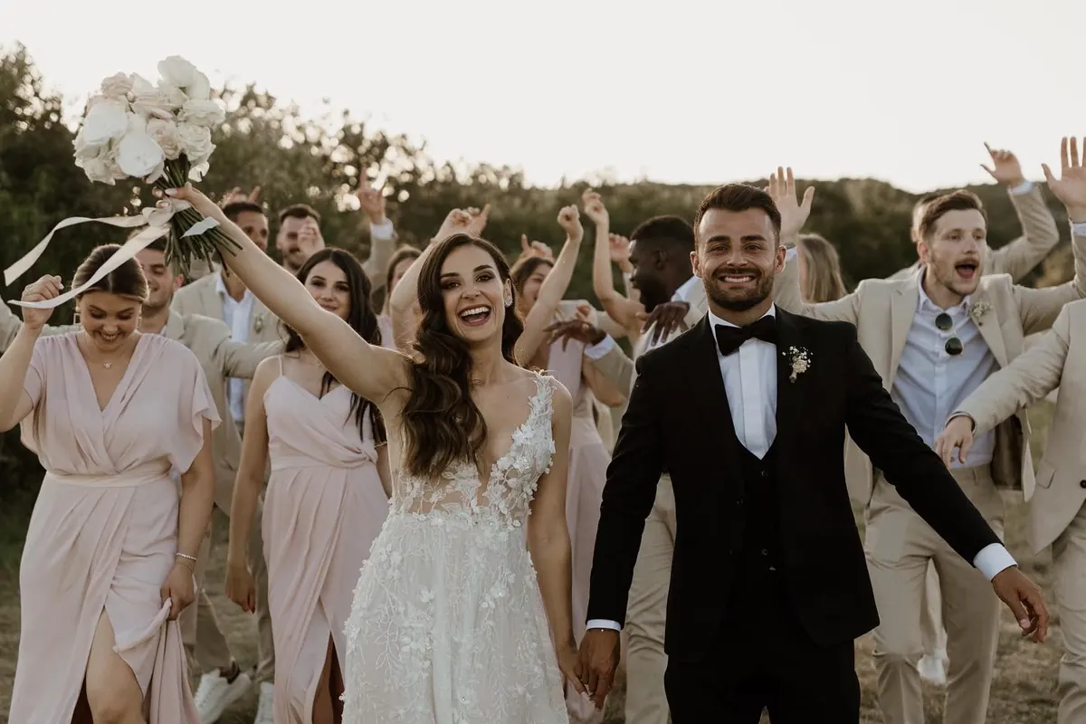 The couple and their guests, arms in the air
