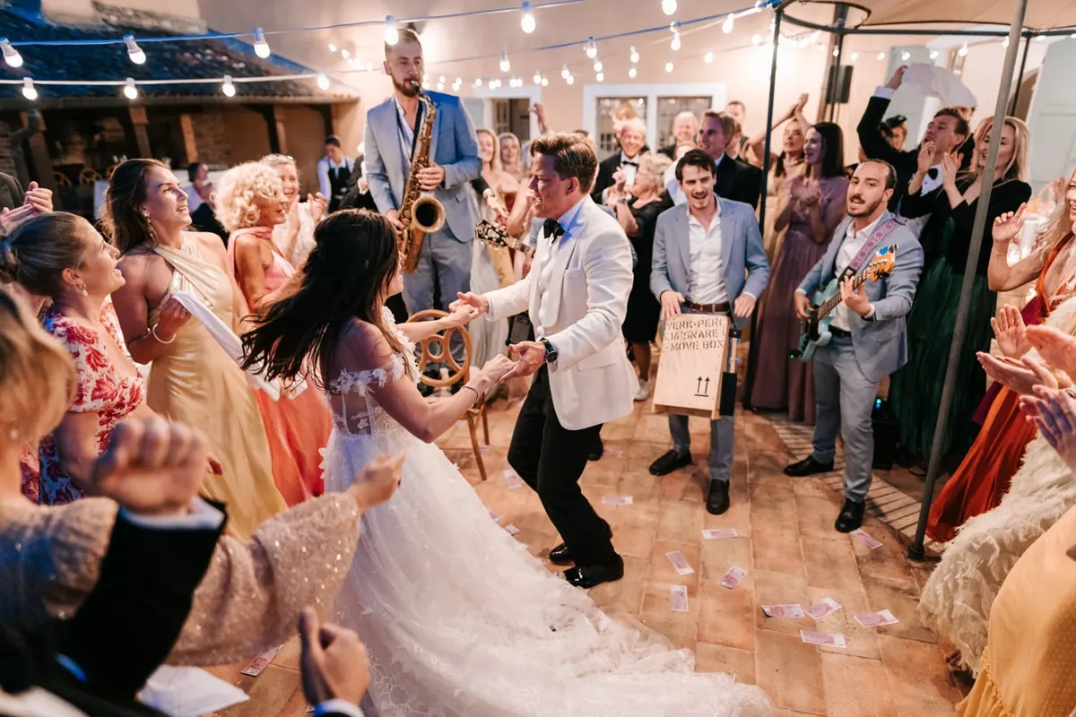 The couple dancing under a canopy of lights